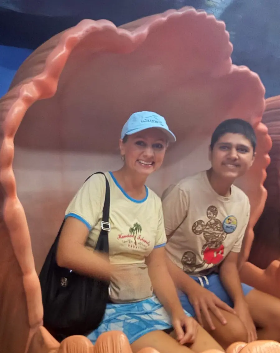 Olga and her son sitting together inside a giant seashell on a family day out